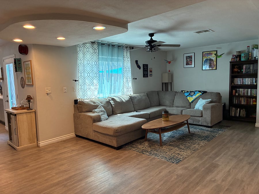 Large living room furnished with a full size couch.