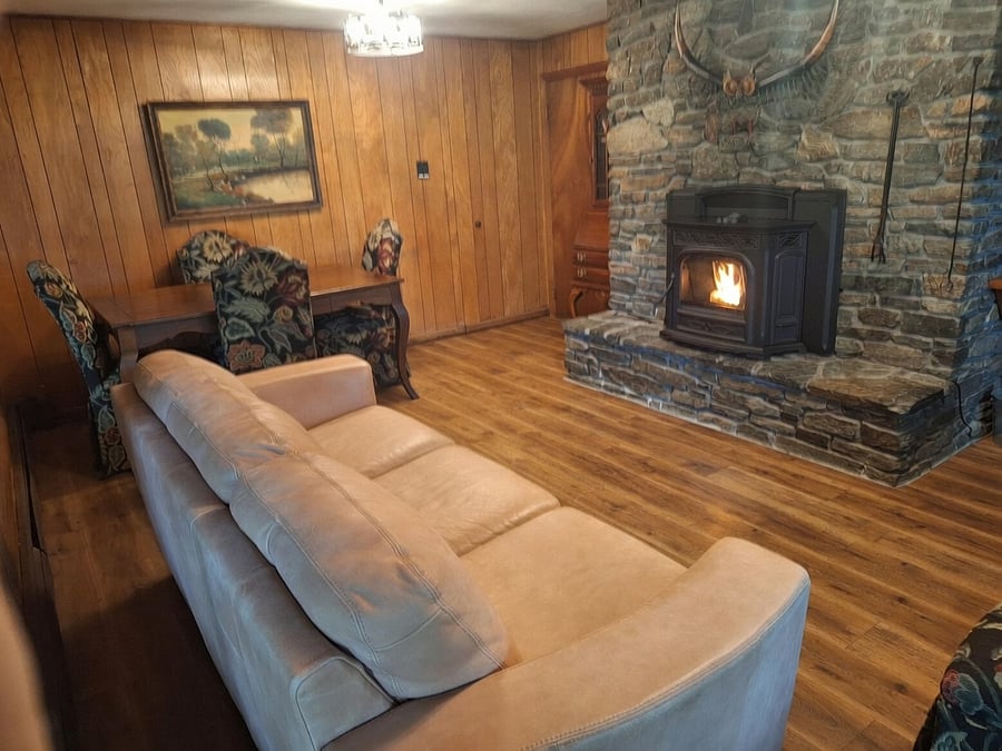 Lower-level den/living room with great views, garden entrance, and new pellet stove.