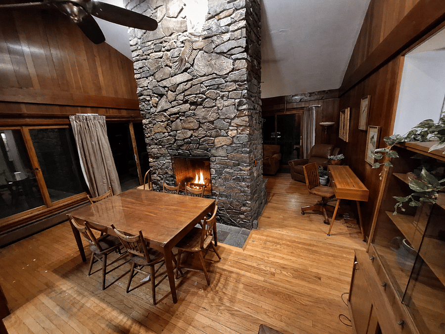 Dining room featuring double sided fireplace into living room.