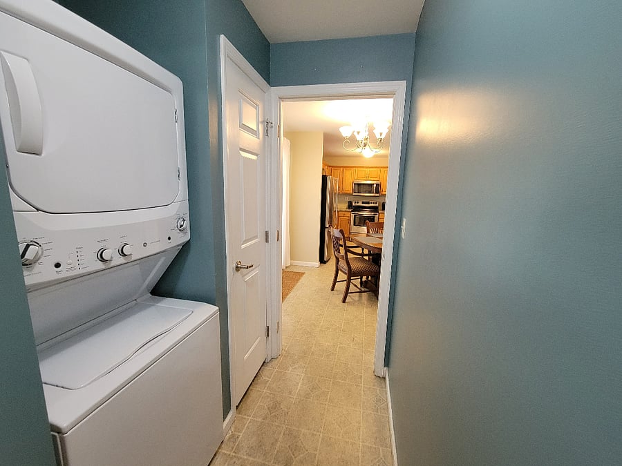 Entrance hall with washer/dryer on left.