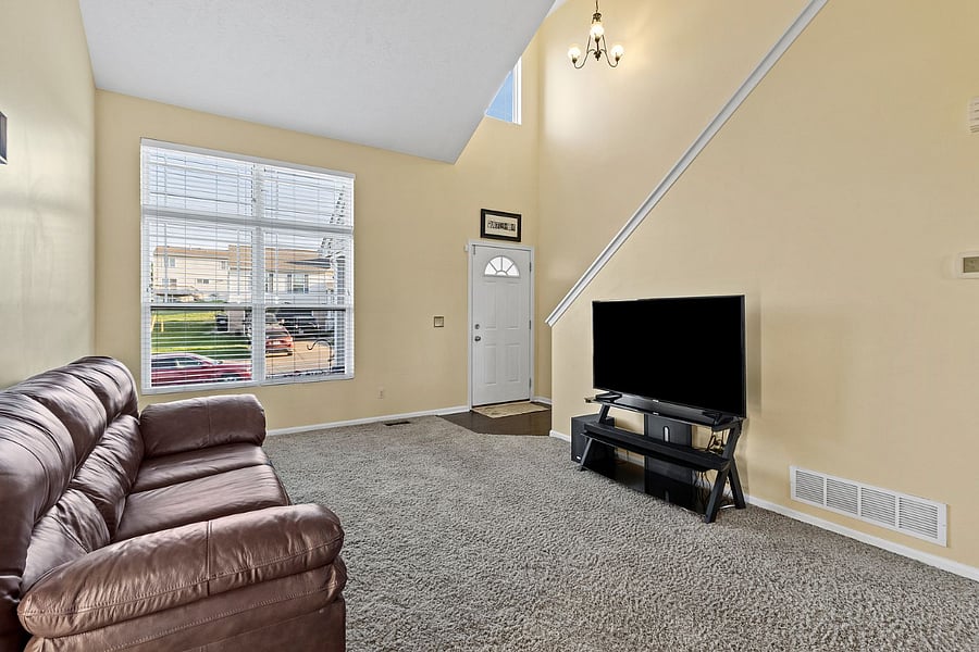 Front door from main living area with open vaulted ceilings.
