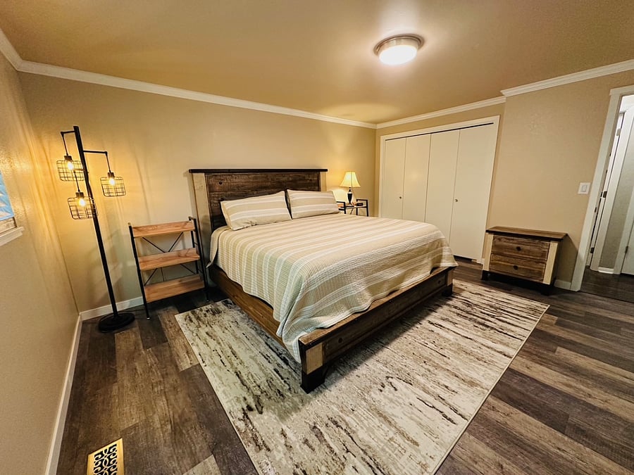 Main Bedroom with King sized bed and large closet and tv mounted on the wall