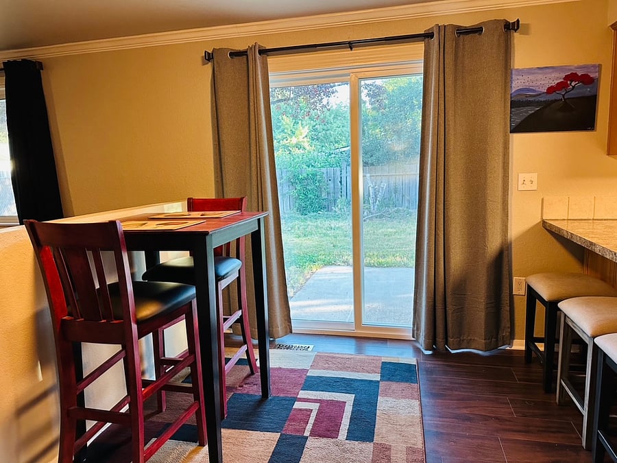 Dining area with Bistro table for 2 and stool seating for 3 at the counter