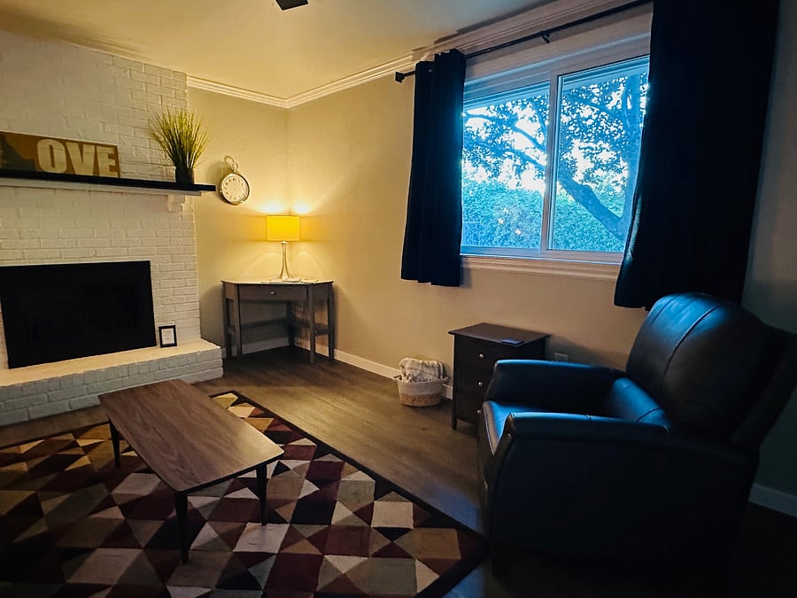 Relaxing sitting room with fireplace and corner desk
