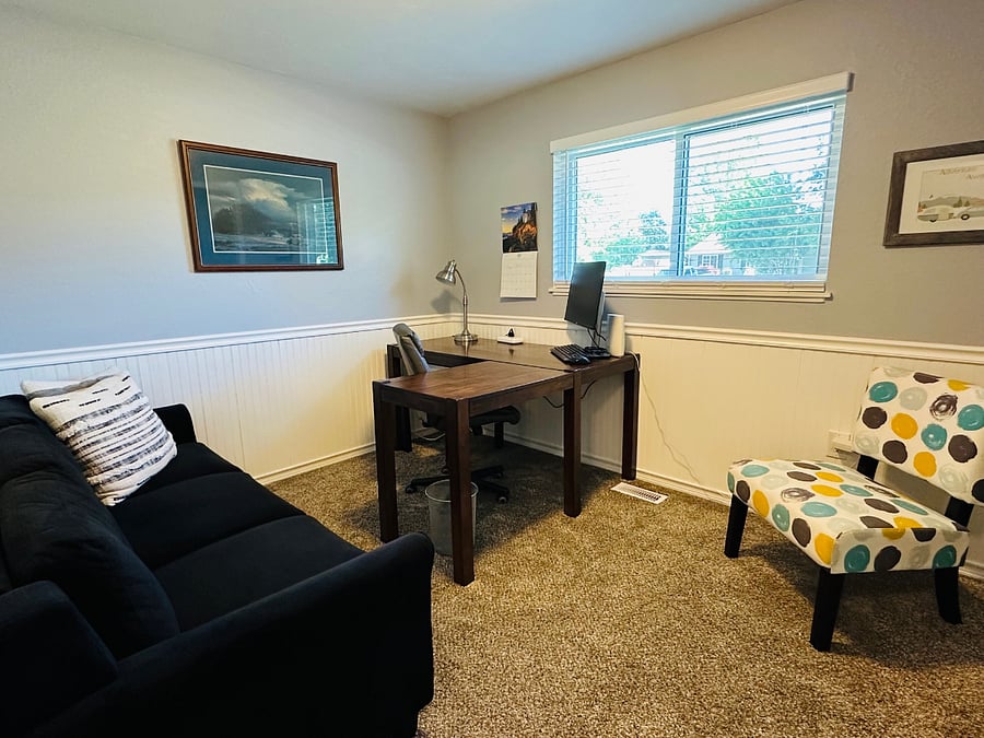 Office has couch and an extra chair for visiting
