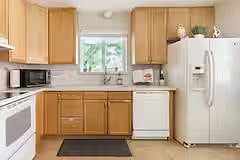 Full kitchen with dishwasher fridge, freezer, microwave, pots pans dishes, toaster, coffemaker