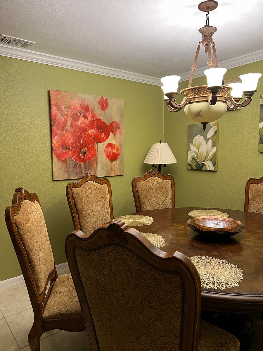Dining room with six-person table and chandelier.