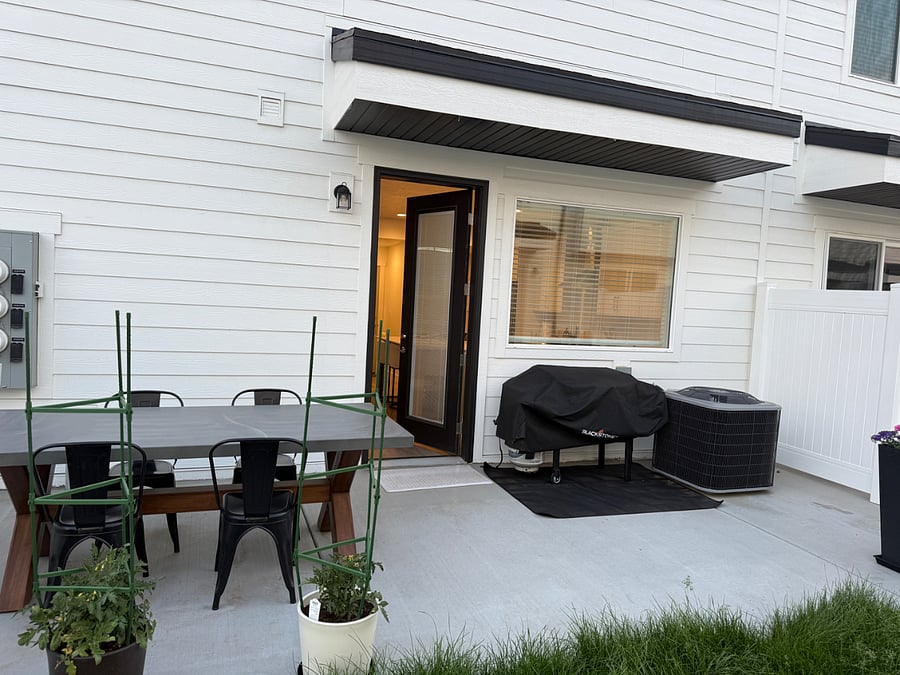 Patio with Blackstone Grill, table and flowers