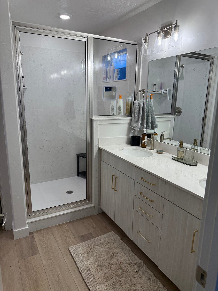 Main bathroom double sink vanity, large shower, and separate toilet closet