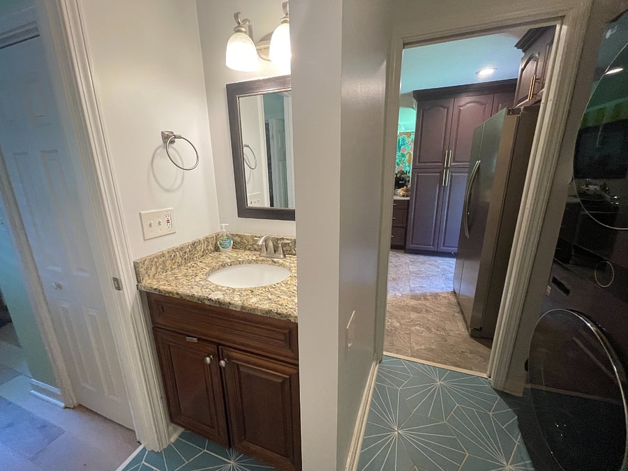 Bathroom 2 - attached to Bedroom 2 with laundry inside and pass through to Kitchen