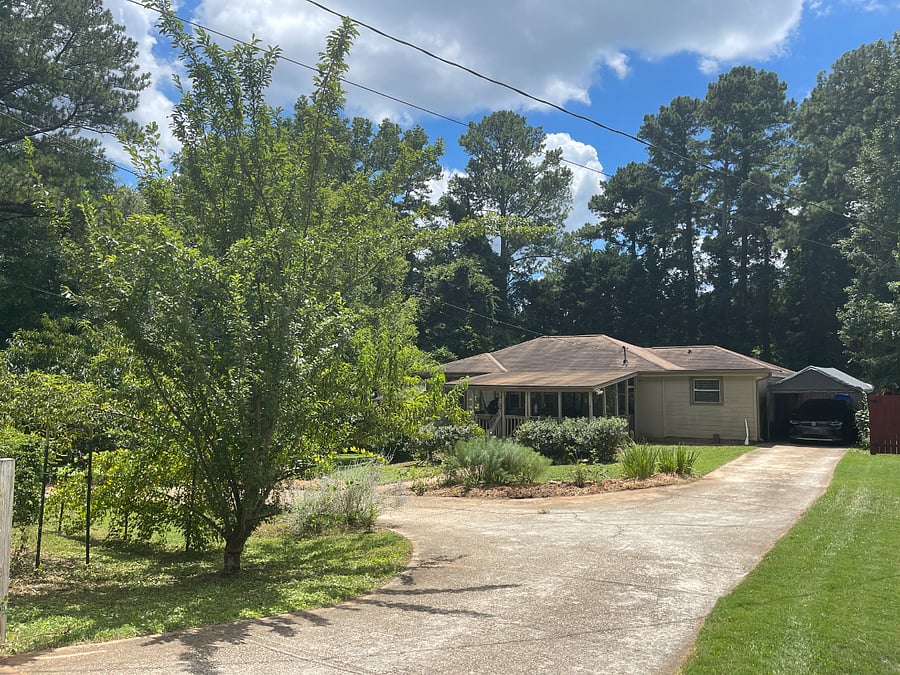 View from the main driveway, carport and EV charging station.