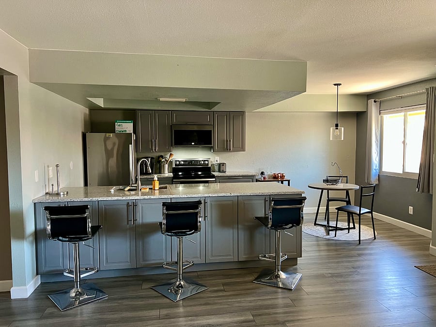 More kitchen storage and barstools on this side of the peninsula.