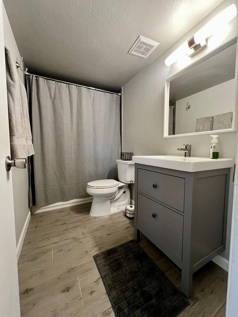 Hallway bathroom with shower and tub.