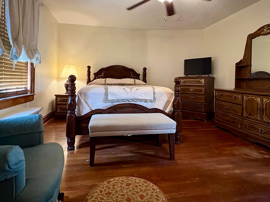 Queen bedroom. Private. Includes: Roku TV, hair dryer, bed linens, window AC, ceiling fan, towel hanger, shoe tray, shower caddy.