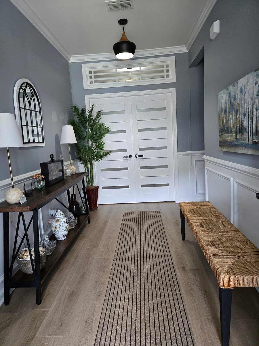 This elegant hallway leaves a warm first impression with its modern decor. Guests will love the inviting vibe and tasteful accents.