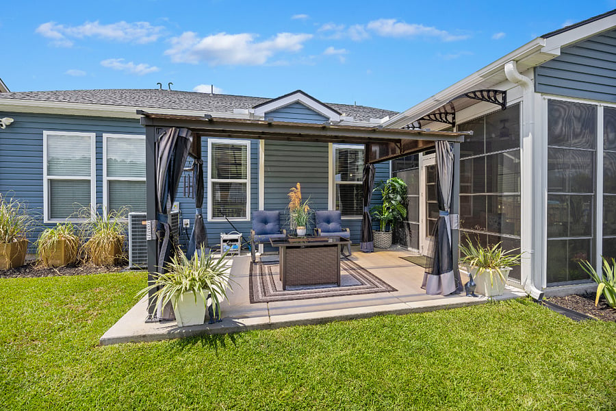 Unwind on your private patio under a shaded pergola, surrounded by lush plants and cozy seating. You will love this stylish outdoor living space. Its the perfect spot to relax and recharge.