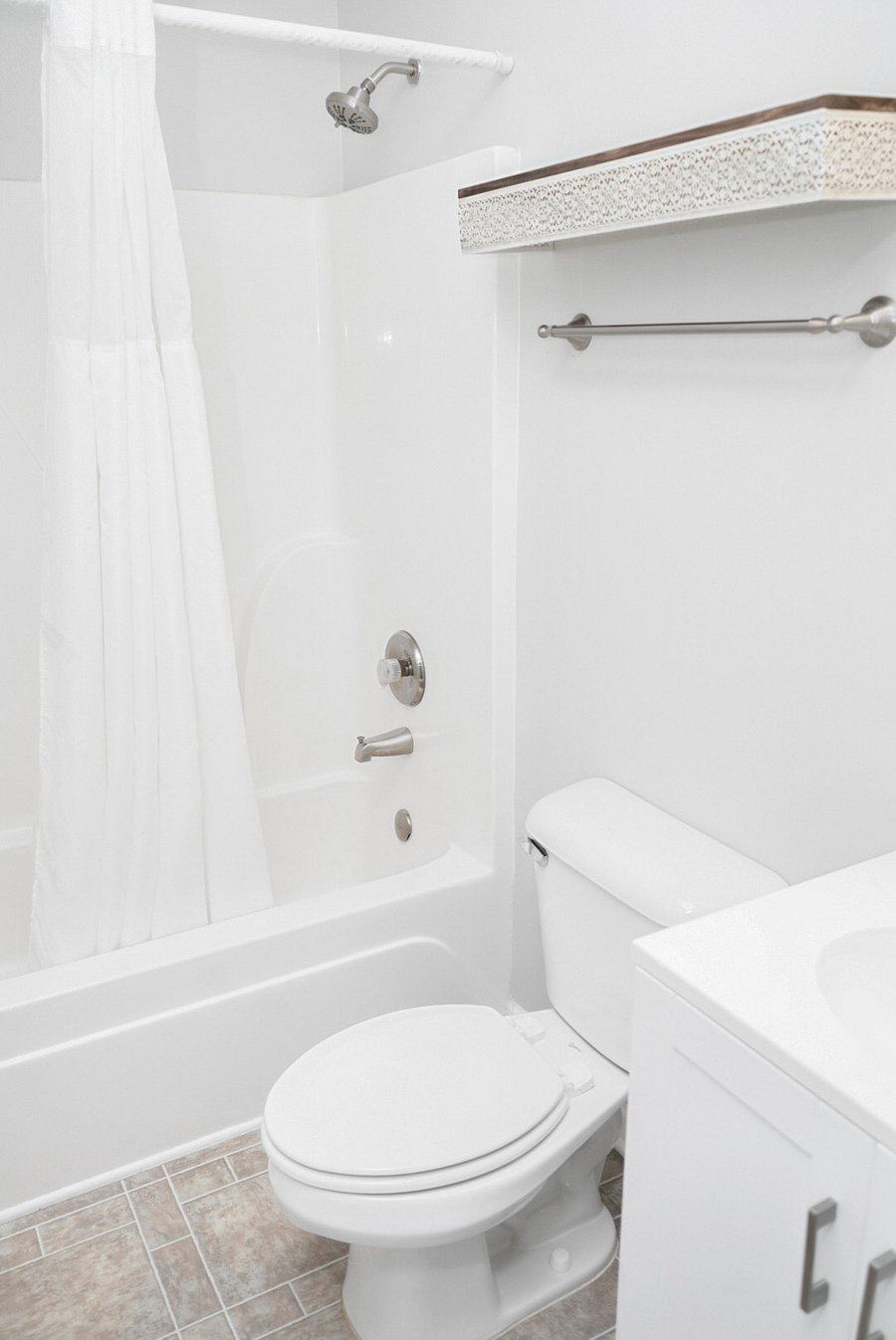 Freshen up in this clean, modern bathroom featuring a full shower and tub combo. All the essentials are provided to make you feel comfortable and right at home.