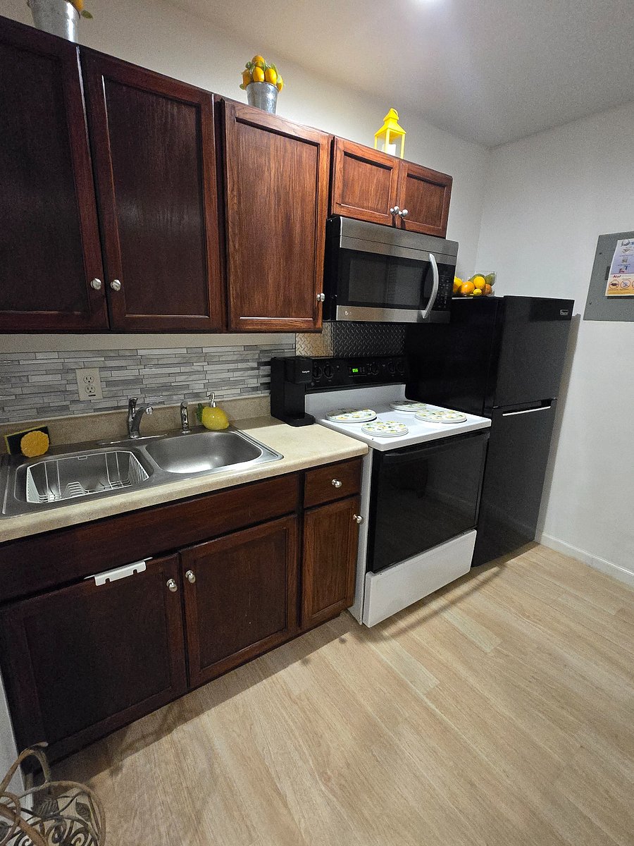 A full stove, apartment size refrigerator and a large microwave oven