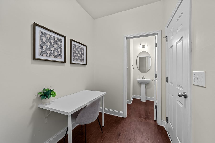 Downstairs half bath, desk area and garage entry door
