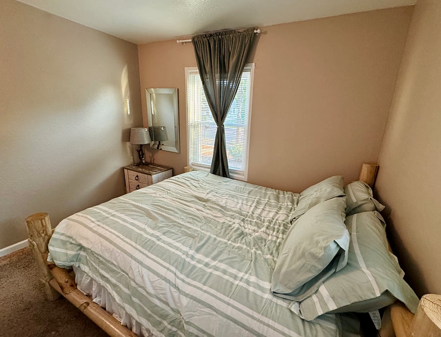 Queen-sized mattress on a log frame bed