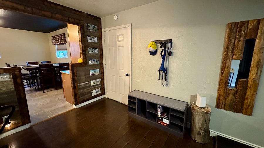 Entrance to single-car over-sized garage with hooks on the wall