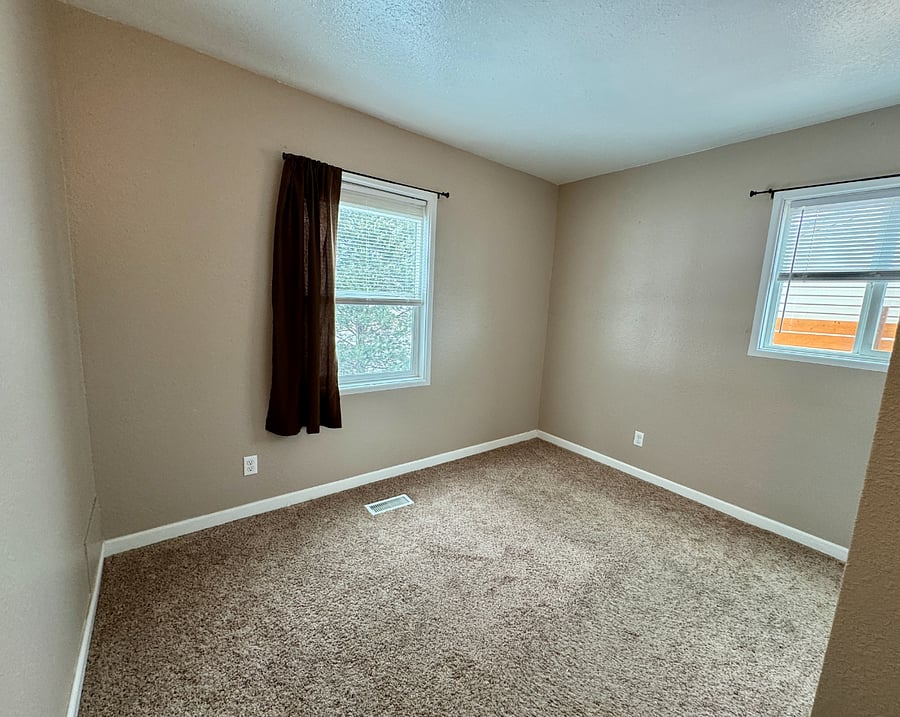 Larger guest room fits queen-sized mattress. Has two windows