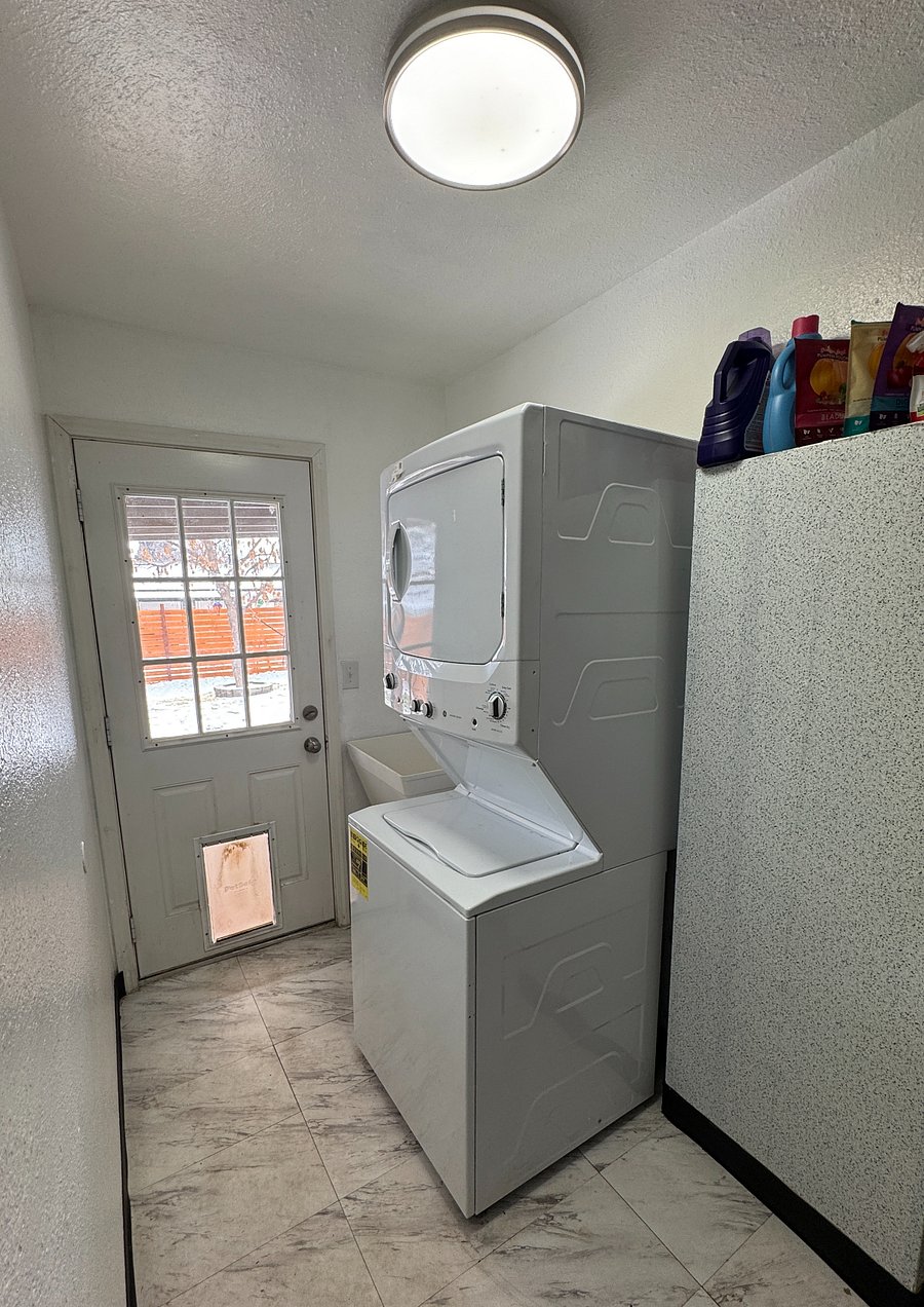 Laundry (in-unit) with back door to covered patio including doggy door. 