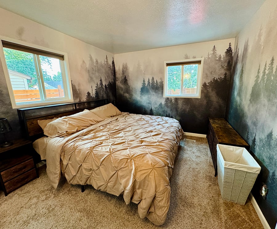 Master bedroom, has a 6-drawer dresser and two nightstands with lamps.