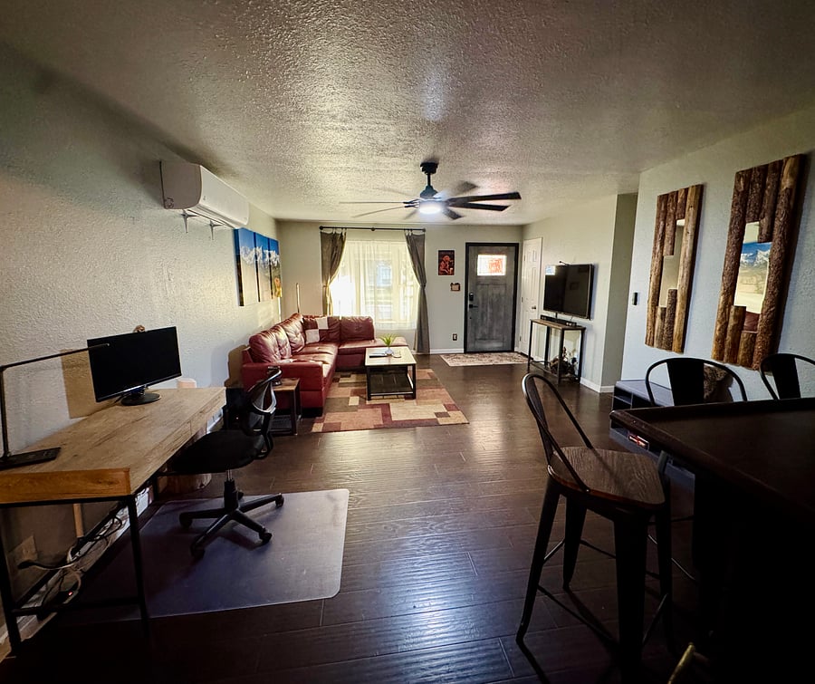 View from kitchen of the front door and mounted TV