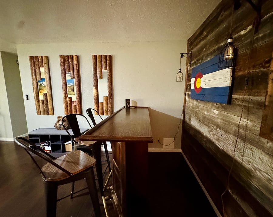 Bar has cabinets with drinkware and accessories