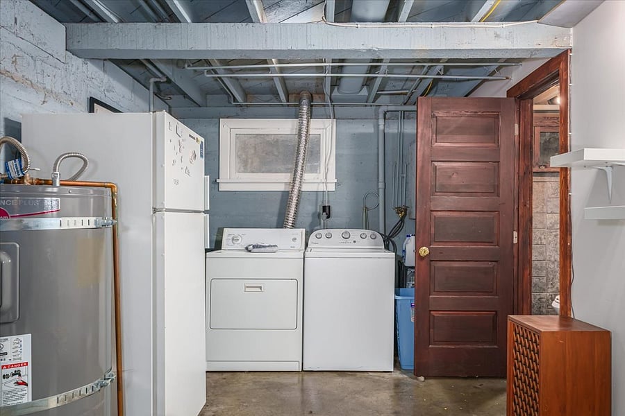 washer and dryer area in basement living space. drying rack and hangers are included in this home's amenities second refrigerator downstairs for big Costco runs