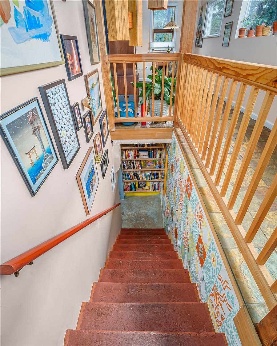 stairs to downstairs living area have motion sensing lights, beautiful midcentury light fixture, art subject to change. 