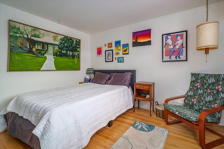 upstairs bedroom with full size bed, chest for clothes, and closet art subject to change