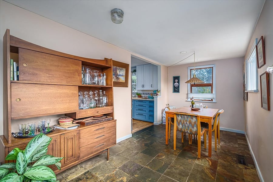 dining room and mid century bar leads to stairs down and back patio