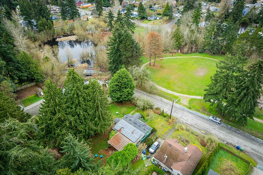 house in winter, some pine needles on the covered back patio, solar panels (but your utilities are included) and the park at your front steps!