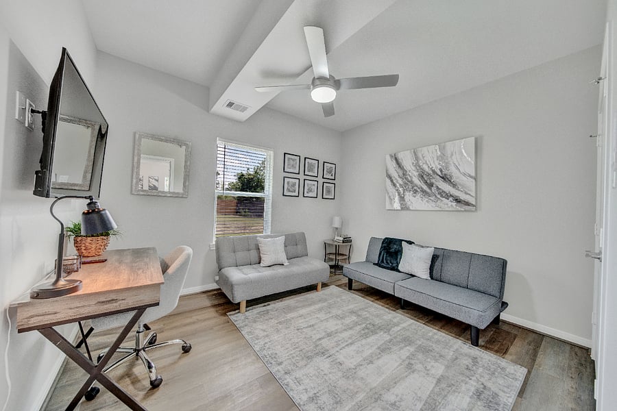 This beautifully designed and versatile room is perfect for a home office or cozy living space. This room features modern decor with a neutral color palette, a stylish wooden desk with an ergonomic chair, a flat-screen smart TV, and two futons when the kids come to visit.