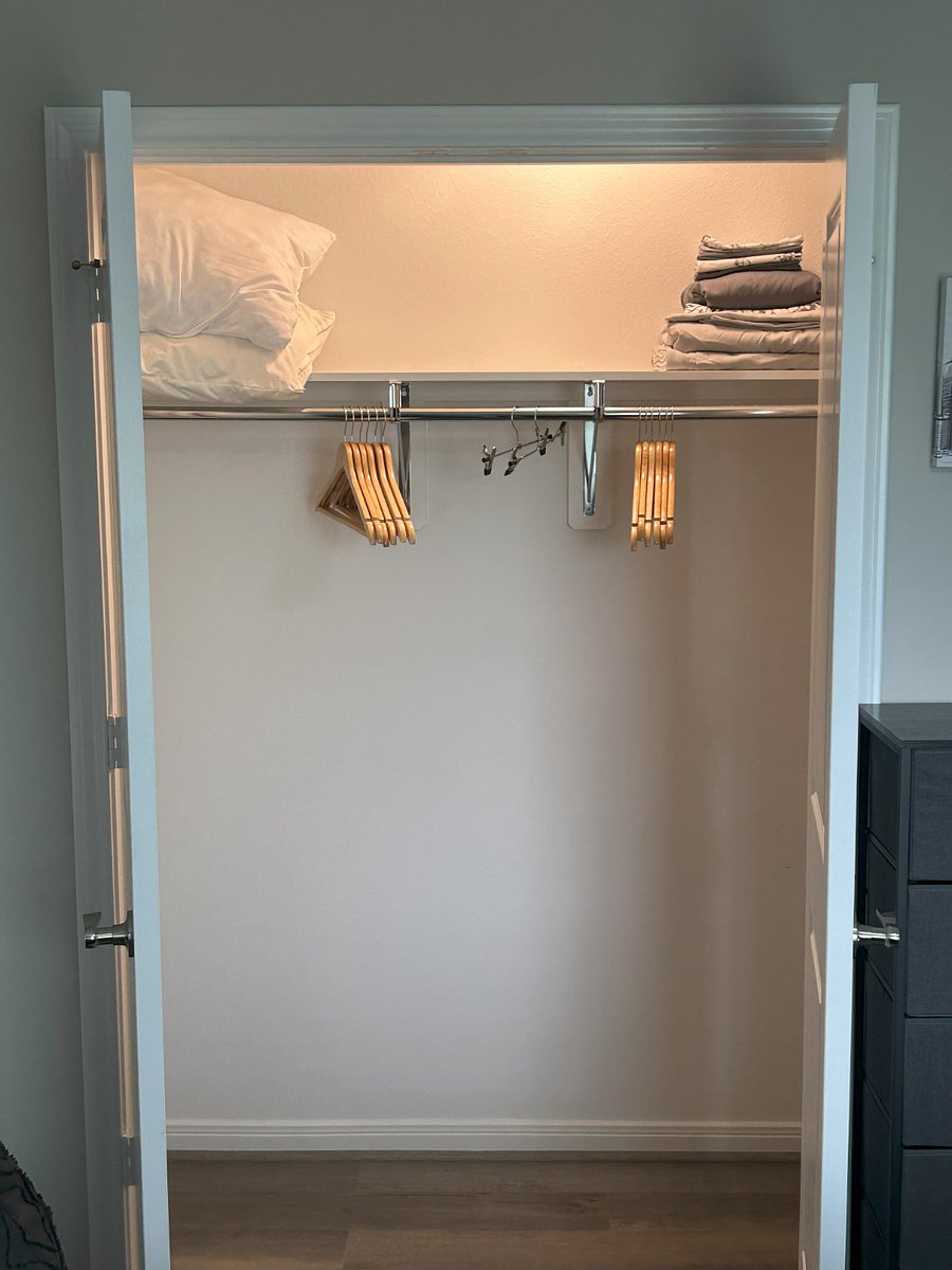 The closet within the monochromatic room. There is also an eight-drawer fabric dresser available for additional storage.