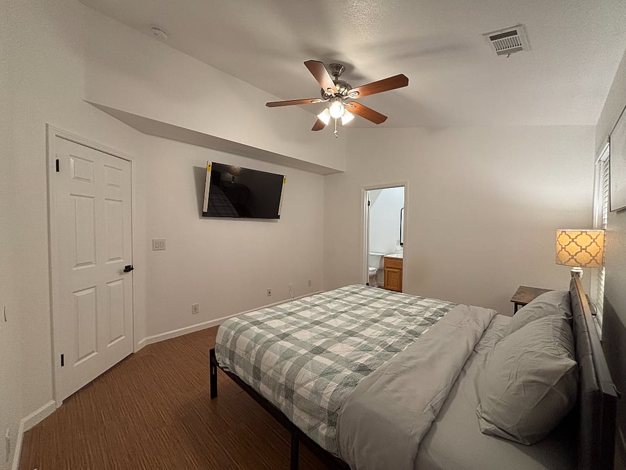 Master bedroom with brand-new King bed and smart TV.