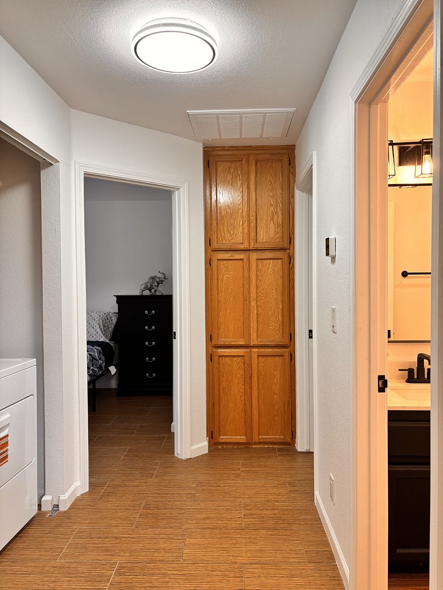Hallway to 2 bedrooms, second bathroom, washer and dryer inside closet