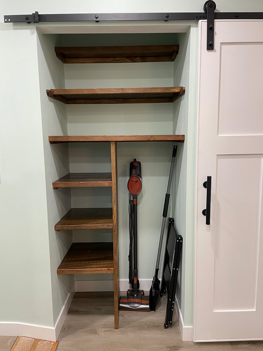 Storage/pantry with vacuum, mop and step stool.