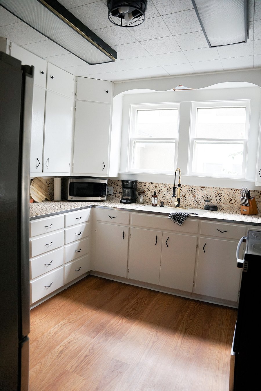Kitchen is stocked with needed necessities including coffee maker, pots, pans, blender and flatware.