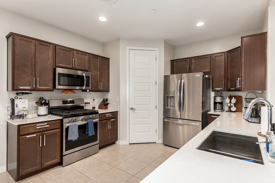 Full kitchen with stainless steel appliances, pantry, granite countertops, and modern cabinetryfully stocked and ready to cook.