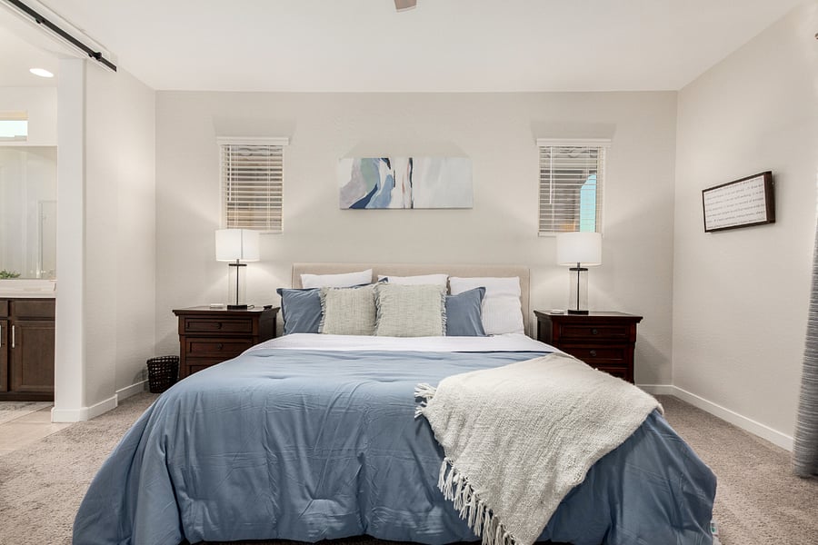 Spacious primary suite with king bed, blackout curtains, and modern farmhouse touches. Attached bathroom with shower, walk in closet, dual vanity