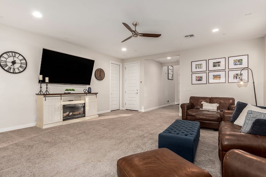 Cozy living space with mounted Smart TV, fireplace, and comfortable seating for relaxing or entertaining.