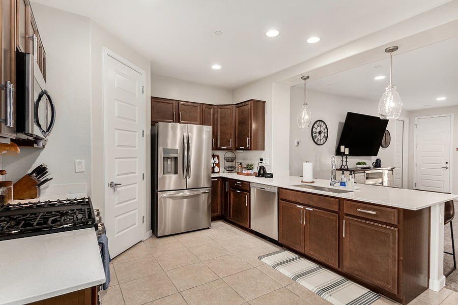 Open kitchen with breakfast bar, large dining area, and TV view from every angle for easy flow and function.