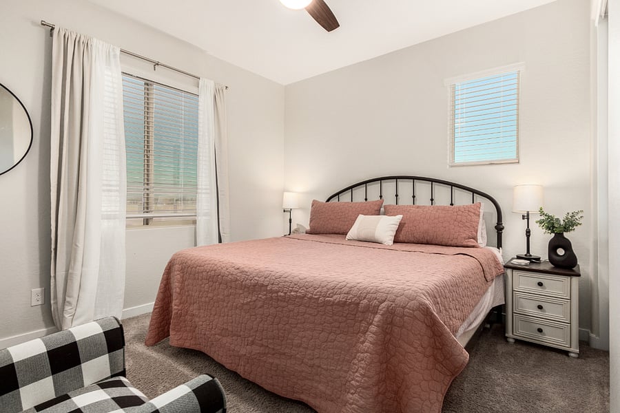 Bright guest room with calming decor, soft lighting, and a plush bedperfect for restful nights.