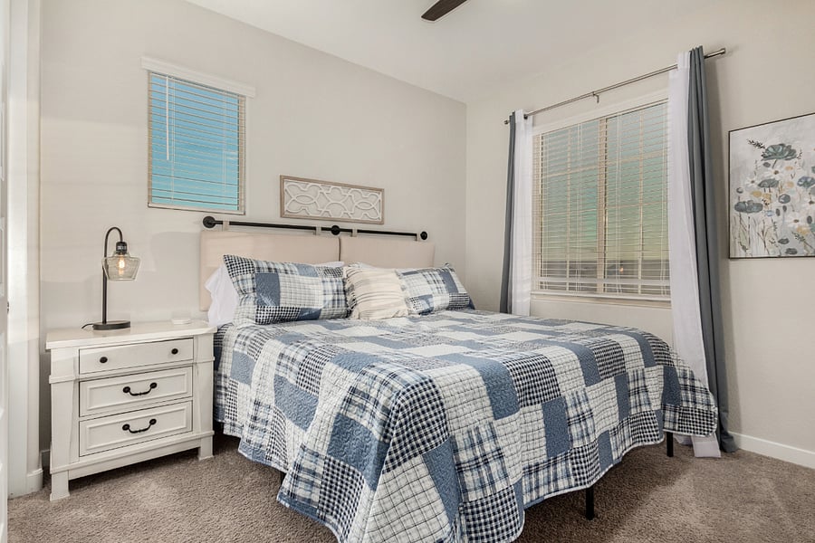 Guest room with coastal-inspired bedding, nightstands, and thoughtful touches for longer stays.