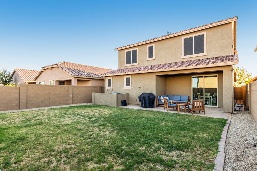 Expansive private yard with grassy space, covered patio, BBQ grill, and plenty of room to unwind.
