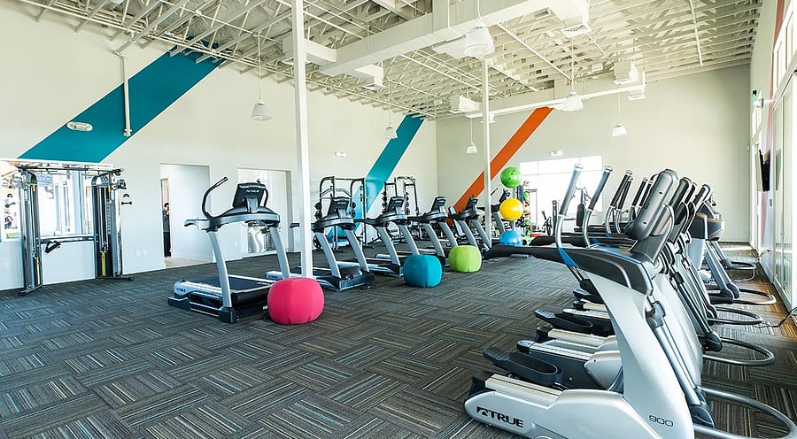State-of-the-art fitness center with cardio machines, weights, and space for yoga or group workouts.