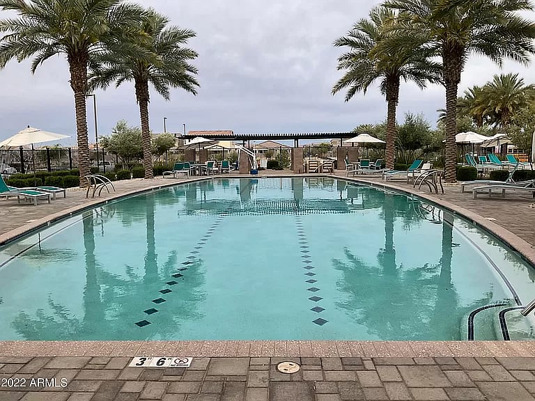 Resort-style lap pool surrounded by palm trees, shaded loungers, and tranquil vibesperfect for morning swims or relaxing afternoons.

